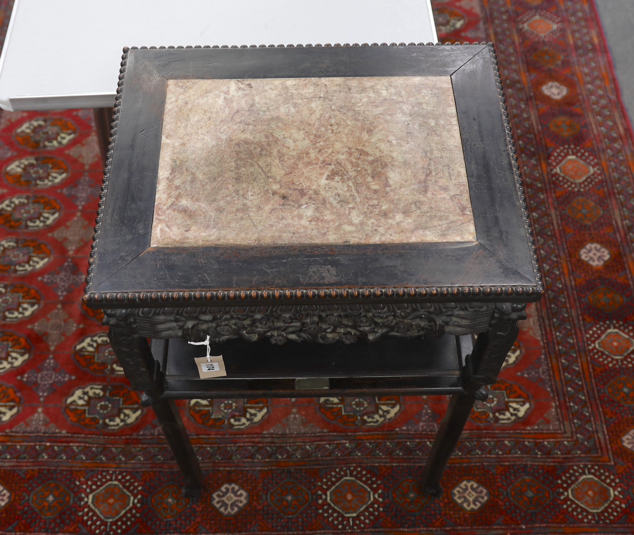 A Chinese carved hardwood marble topped rectangular two tier table, width 51cm, depth 40cm, height 80cm